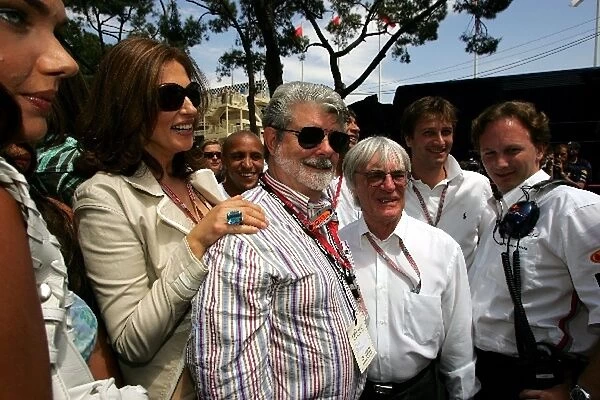 Formula One World Championship: George Lucas with Bernie Ecclestone F1 Supremo on the grid