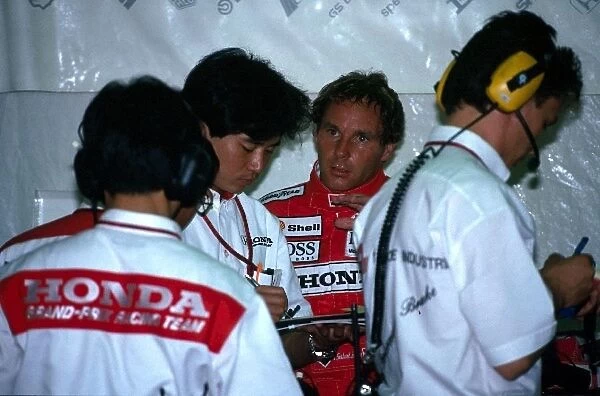 Formula One World Championship: Gerhard Berger McLaren confers with the Honda engineers in the pit garage
