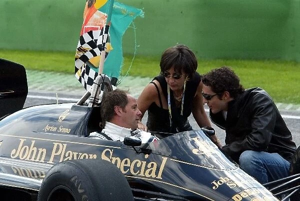 Formula One World Championship: Gerhard Berger with Viviane Senna and her son Bruno, prepares to drive an ex-Ayrton Senna Lotus 98T