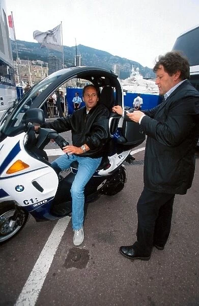 Formula One World Championship: Gerhard Berger BMW Competitions Director aboard a BMW C1:200 moped talks with Norbert Haug Mercedes Motorsport