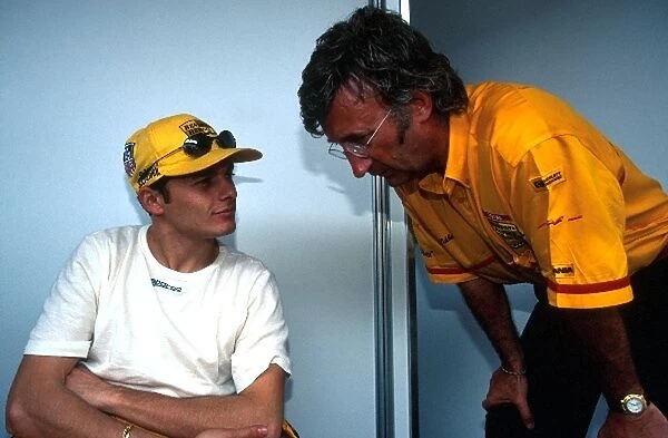 Formula One World Championship: Giancarlo Fisichella has a discussion with Team Boss Eddie Jordan
