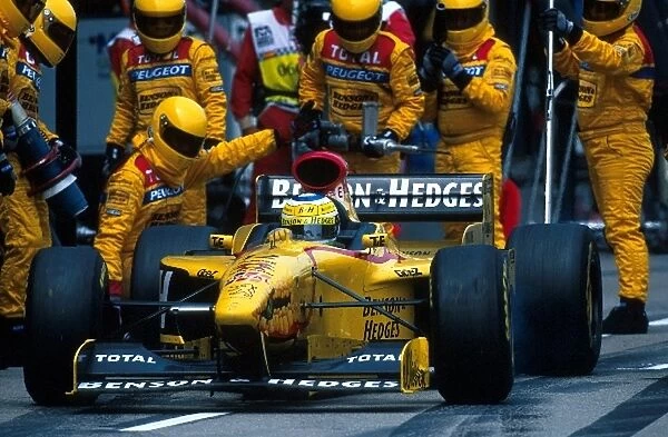 Formula One World Championship: Giancarlo Fisichella Jordan Peugeot 197 leaves his mechanics behind as he leaves the pits