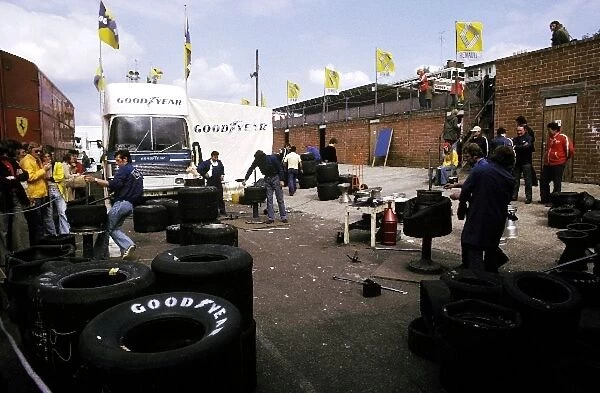 Formula One World Championship: The Goodyear tyre technicians work in the paddock area