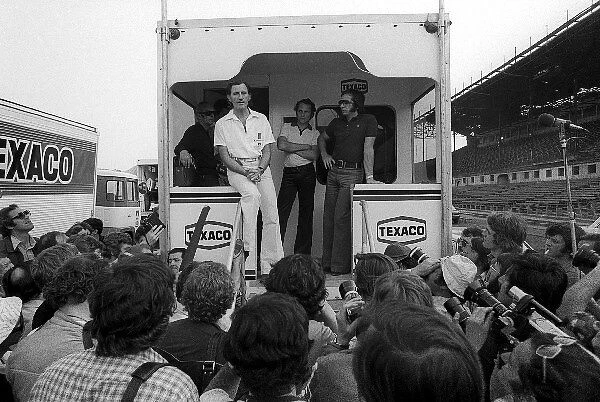 Formula One World Championship: Graham Hill Hill Team Owner, as a GPDA representative, explains from the back of the McLaren motorhome on the