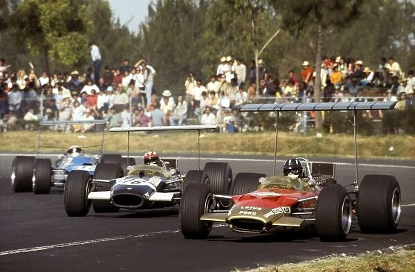 Formula One World Championship: Graham Hill Lotus Cosworth 49B, leads pole position man Jo Siffert in a similar Rob Walker Racing entered car