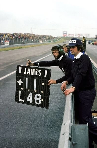 Formula One World Championship: A Hesketh mechanic holds out the pit board from the pit wall for James Hunt, who went on to take his and HeskethÕs