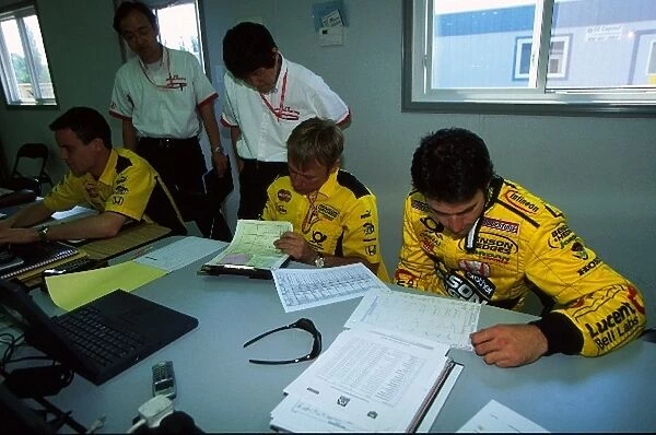 Formula One World Championship: Honda technicians, David Brown and Ricardo Zonta examine telemetry read outs