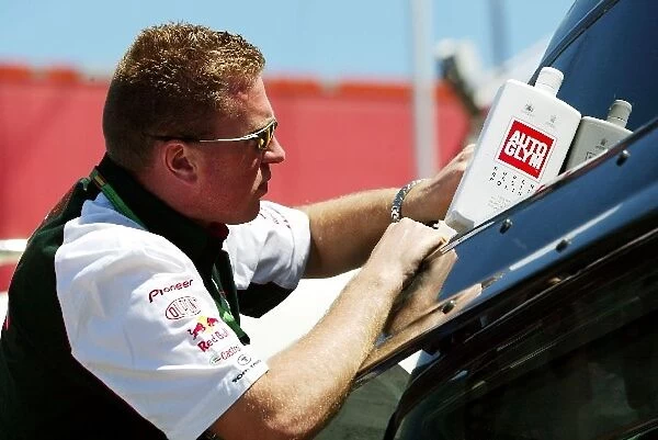 Formula One World Championship: A Jaguar mechanic cleans a lorry with Auto Glym