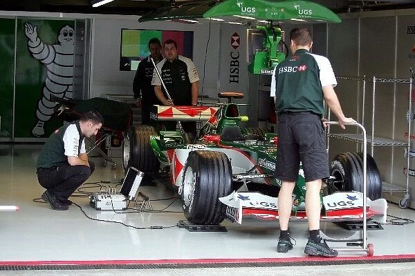 Formula One World Championship: Jaguar mechanics prepare a Jaguar F1 car for the last time