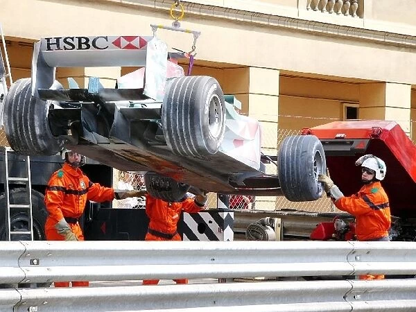 Formula One World Championship: The Jaguar R5 of Mark Webber is removed from the track when his engine blew
