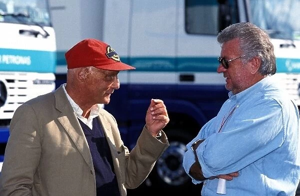 Formula One World Championship: Jaguar Team Principal Niki Lauda talks to Willi Weber Manager of the Schumacher brothers