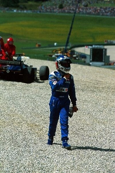 Formula One World Championship: Jean Alesi Prost Peugeot AP3 walks away from his car after retiring