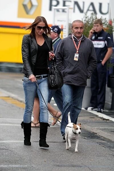 Formula One World Championship: Jenni Raikkonen in the paddock with a dog