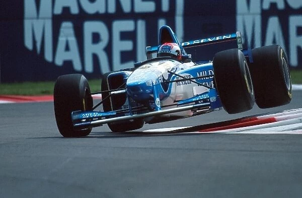 Formula One World Championship: Johnny Herbert Benetton B195 jumps the curbs on the way to 1st place
