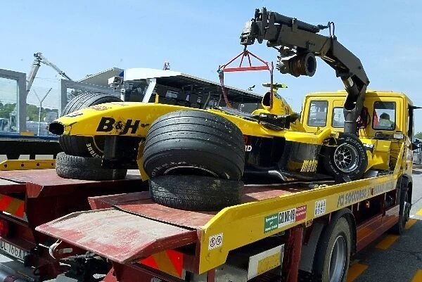Formula One World Championship: The Jordan Ford EJ14 of Timo Glock is returned to the pits after crashing during practice