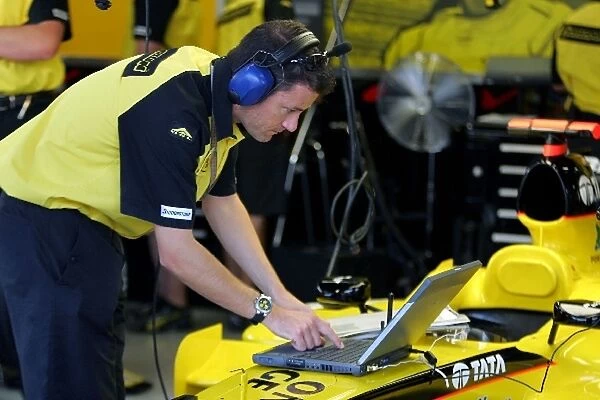 Formula One World Championship: A Jordan mechanic uses a laptop computer