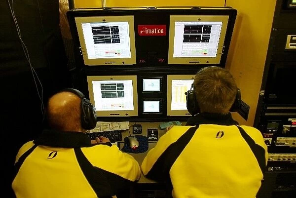 Formula One World Championship: Jordan mechanics use computer equipment in the pit garage