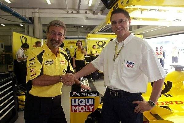 Formula One World Championship: Jordan Team Owner Eddie Jordan with Peter Baumann the Marketing Director of Liqui Moly