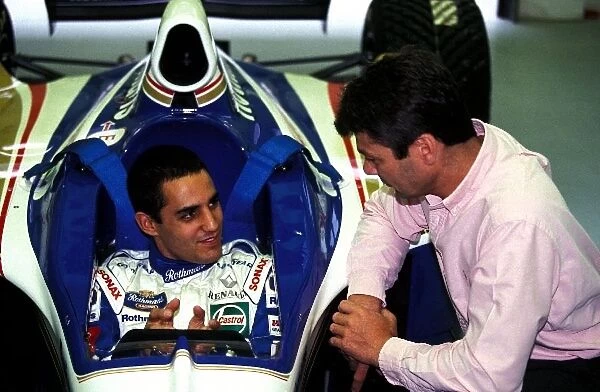 Formula One World Championship: Juan Pablo Montoya sits in a Williams Renault FW19 chatting to Williams Engineer James Robinson