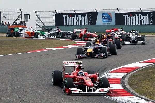 Formula One World Championship: Jump starter Fernando Alonso Ferrari F10 leads at the start of the race