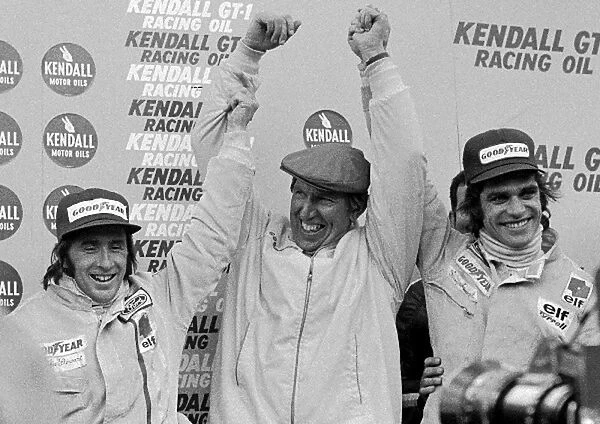 Formula One World Championship: Ken Tyrrell centre, celebrates a 1-2 finish with winner Jackie Stewart left, and Francois Cevert right