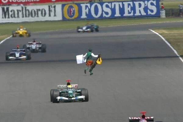 Formula One World Championship: A kilt wearing lunatic aka Father Neil Horan runs at the cars on the Hangar Straight during the race