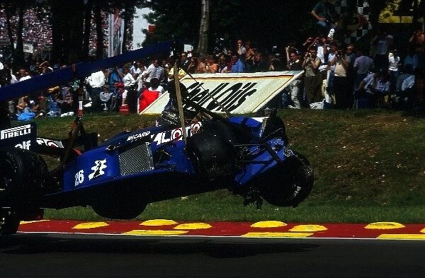 Formula One World Championship: The Ligier JS27 of Jacques Laffite is carried away after a start line crash that sadly ended Laffite├òs F1 career