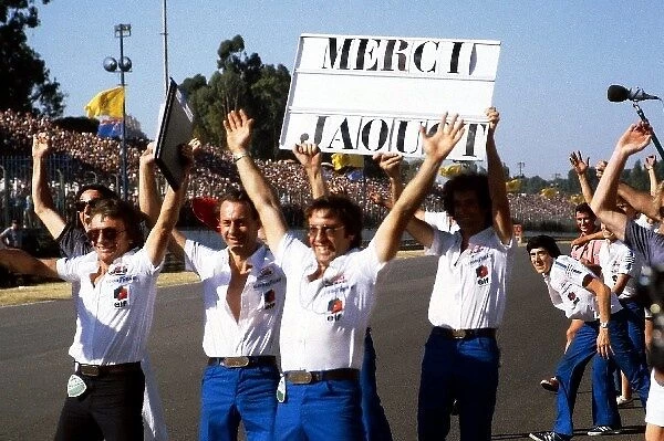 Formula One World Championship: The Ligier team celebrate on the circuit as Jacques Laffite Ligier wins the race