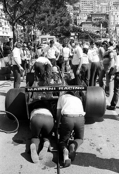 Formula One World Championship: Lotus mechanics work on the Lotus 79 of third placed Carlos Reutemann in the pits