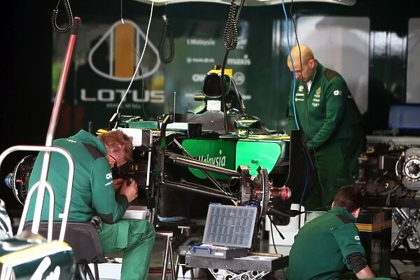 Formula One World Championship: Lotus T127 prepared in the pits
