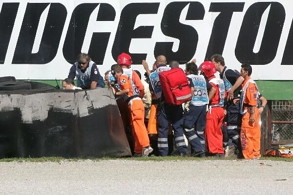Formula One World Championship: Marshals attend to Kimi Raikkonen Ferrari F2007 after he crashed at the Ascari chicane