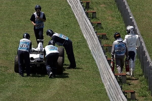 Formula One World Championship: Marshals with the car of Robert Kubica BMW Sauber F1 after a problem during practice