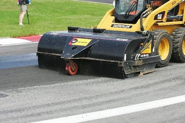 Formula One World Championship: Marshals clean the track surface at turn one