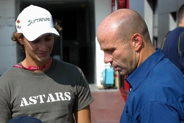 Formula One World Championship: Mathias Lauda chats with former motorcycle racer Randy Mamola at an Alpinestars event