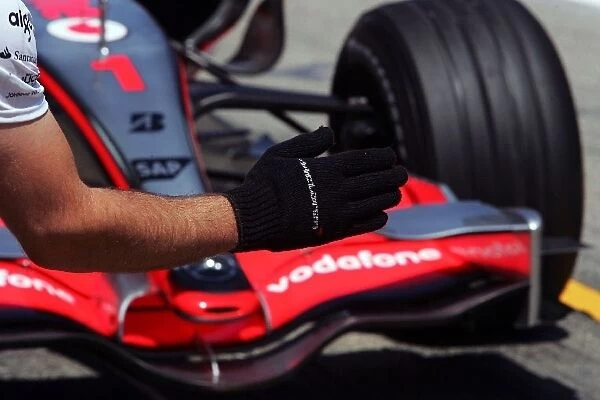 Formula One World Championship: McLaren hand guides Fernando Alonso McLaren into the pit box