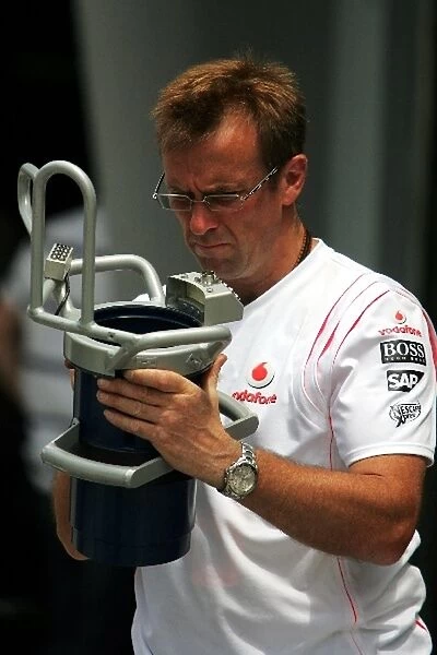 Formula One World Championship: McLaren mechanic with a fuel rig