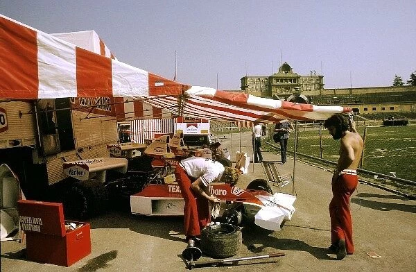 Formula One World Championship: McLaren mechanics work on the M23 of Emerson Fittipaldi in the paddock area hosted in the football stadium in Montjuich Park