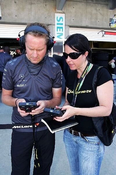 Formula One World Championship: McLaren mechniacs use the Kangaroo TV device