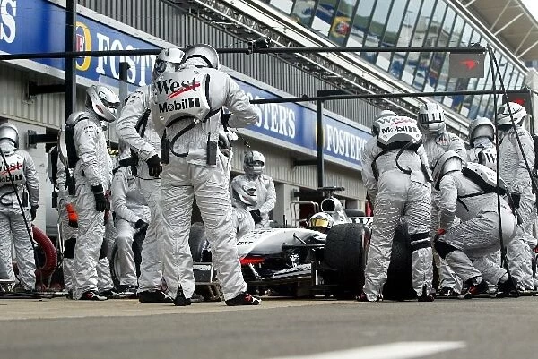 Formula One World Championship: McLaren practice the pitstops on the MP4  /  17 using their new temperature controlled team race suits