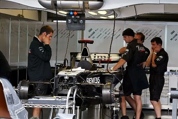 Formula One World Championship: McLaren prepare the MP4  /  19B in the pits
