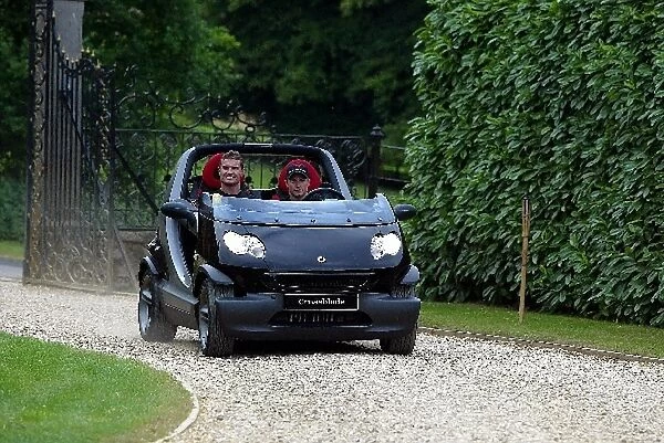 Formula One World Championship: McLaren team mates Kimi Raikkonen and David Coulthard drive an open top Smart car