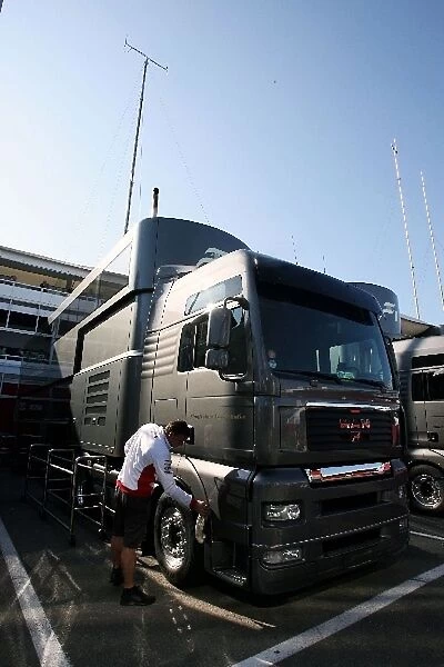 Formula One World Championship: A mechanic polishes one of the Force India trucks