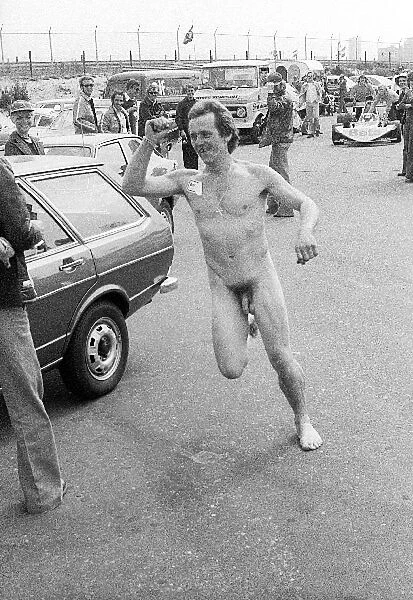 Formula One World Championship: A mechanic runs through the paddock naked except for a Brabham sticker on his chest