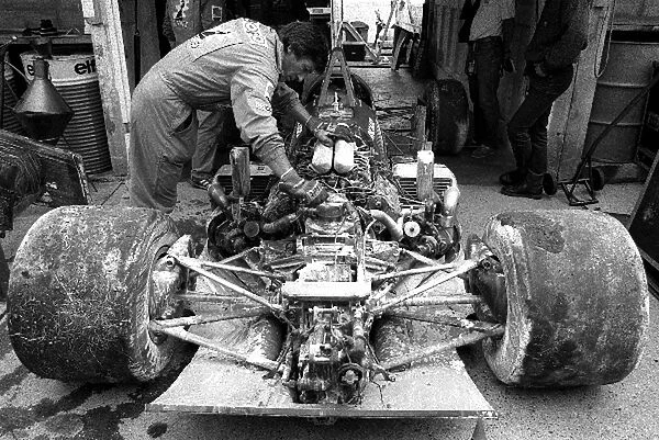 Formula One World Championship: A mechanic surveys the damage to the Ligier JS27 of Jacques Laffite after suffering a major fire when the fuel