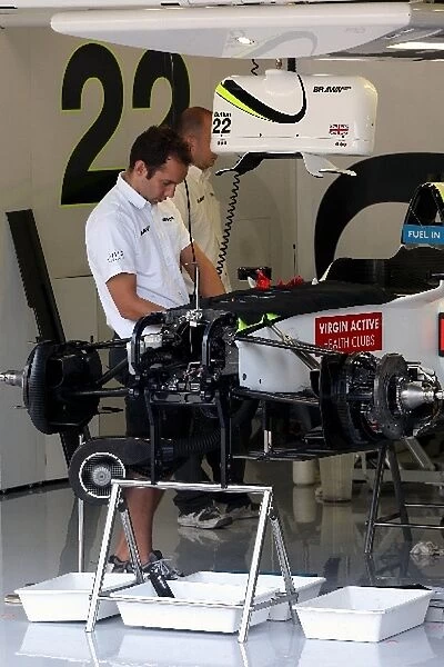 Formula One World Championship: Mechanics prepare the car of Jenson Button Brawn BGP 001