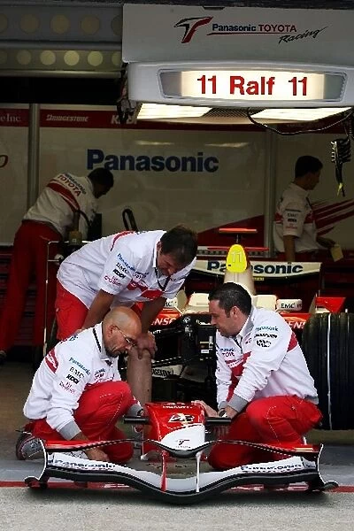 Formula One World Championship: Mechanics work on the Toyota TF107 of Jarno Trulli Toyota