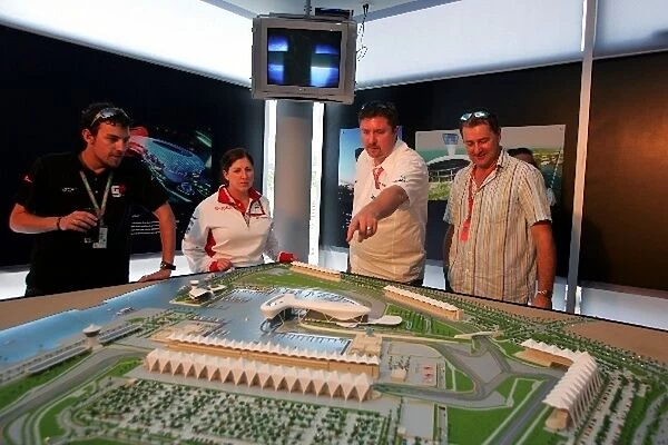 Formula One World Championship: Media and guests with a model of the Yas Marina Circuit in Abu Dhabi on display at the Chinese Grand Prix