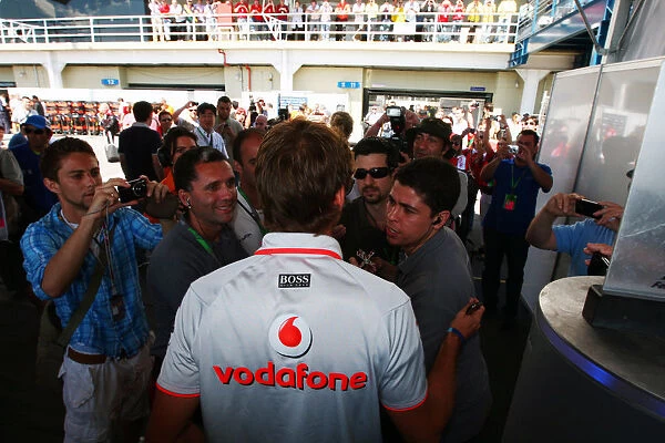 Formula One World Championship: A media scrum follows Jenson Button McLaren the morning after he was subjected to an attempted armed car attack