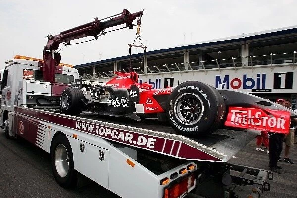 Formula One World Championship: The MF1 M16 of Christijan Albers MF1 Racing returns to the pits on the back of a truck