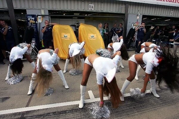 Formula One World Championship: Miami Dolphins cheerleaders outside the Williams garage